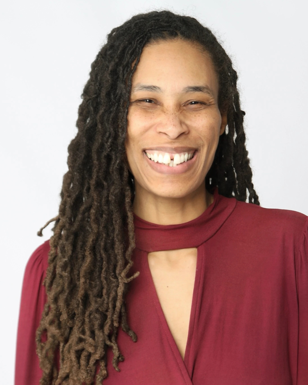 September Faison smiling in a burgundy top